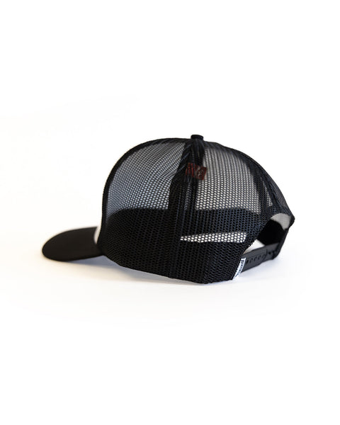 Back of a Black and white trucker hat with a Birdwell  tag on the back on a white background