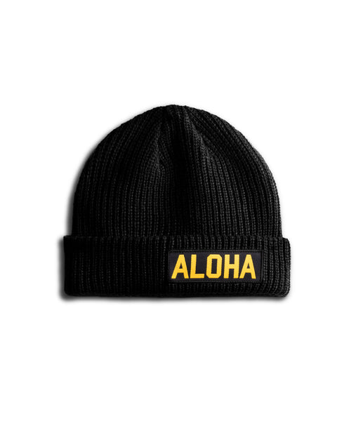 Black Beanie with rectangular Aloha patch  with black background and yellow text.