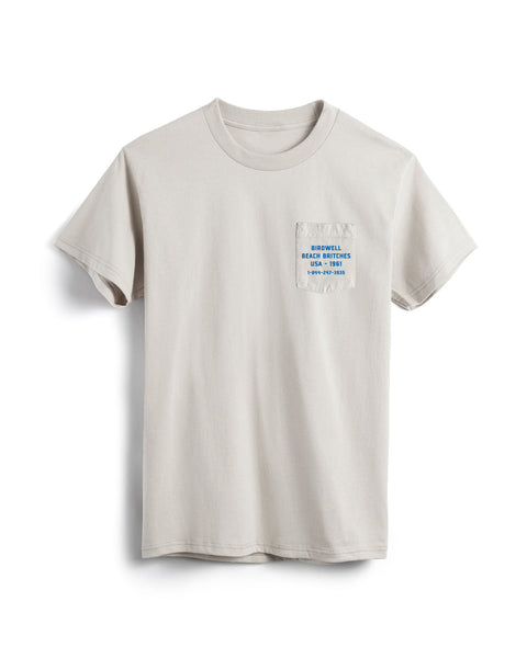 Beige t-shirt with a small pocket and text on a white background
