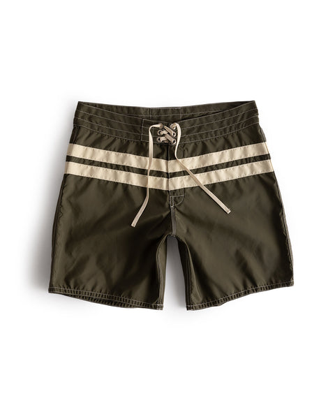 The 300 Comp Stripe boardshorts in dark olive with bone stripes feature a beige drawstring waist and classic design, made in the USA.